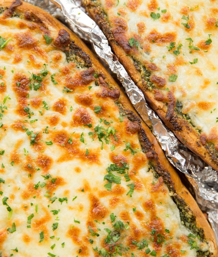 overhead shot of cheesy garlic bread fresh out the oven garnished with parsley