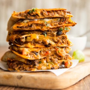 quesadillas stacked on top of each other with filling slightly pouring out