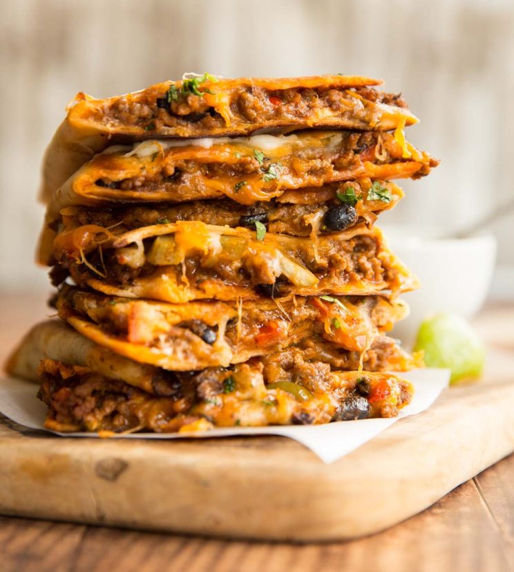 quesadillas stacked on top of each other with filling slightly pouring out