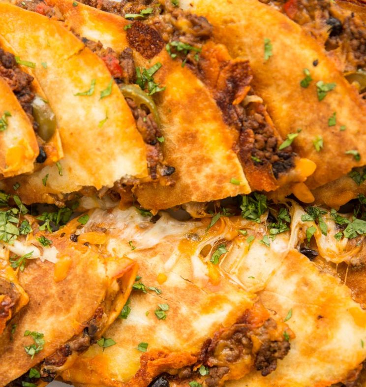 overhead shot of quesadillas sliced in half with cheese pouring out