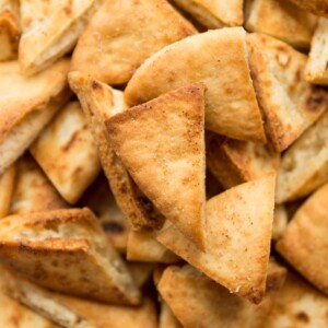 overhead shot of bowl of pita chips, focus on one