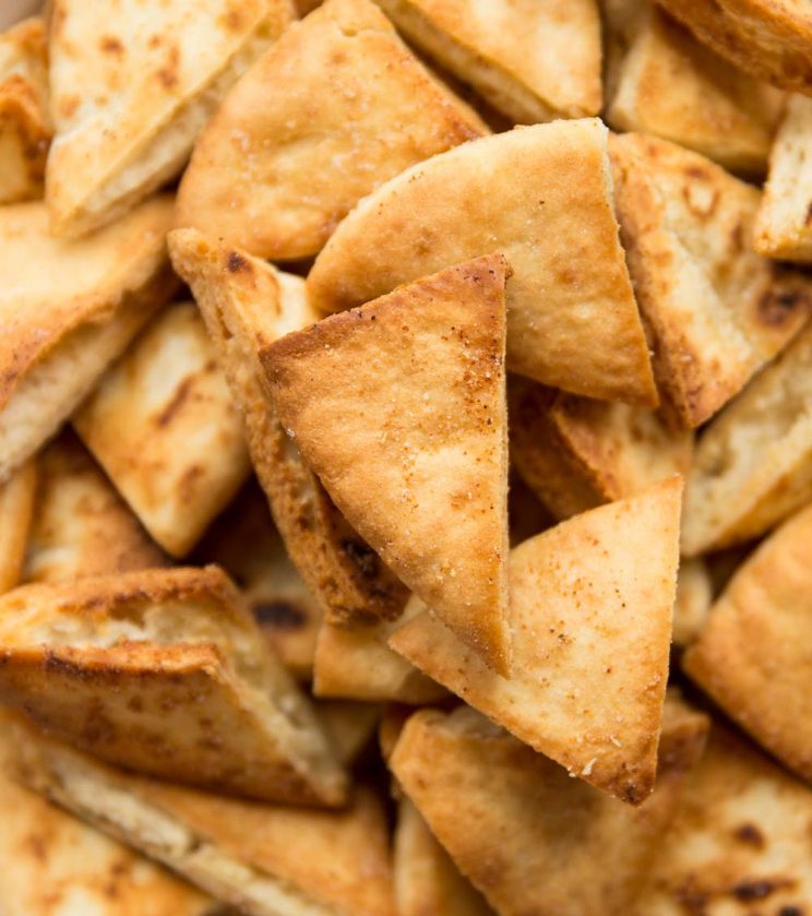 overhead shot of bowl of pita chips, focus on one