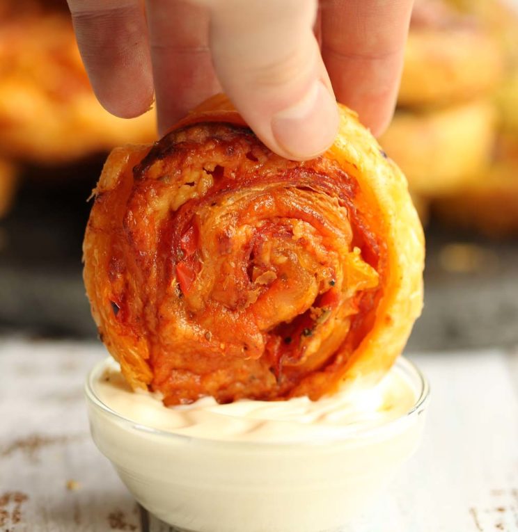 Dipping Pizza Puff Pastry Pinwheels in dip
