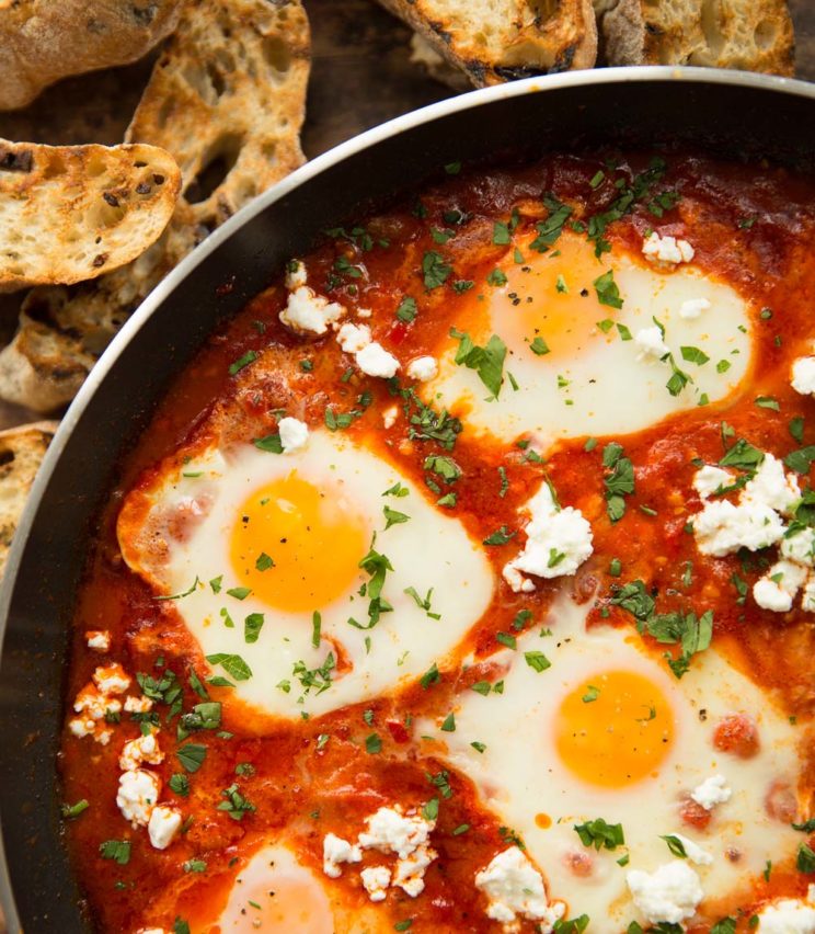 close up of shakshuka garnished with feta and parsley