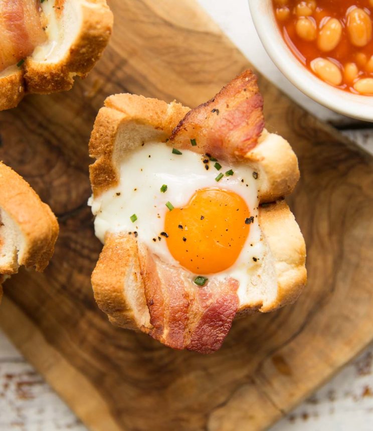 overhead shot of egg toast cup on wooden board