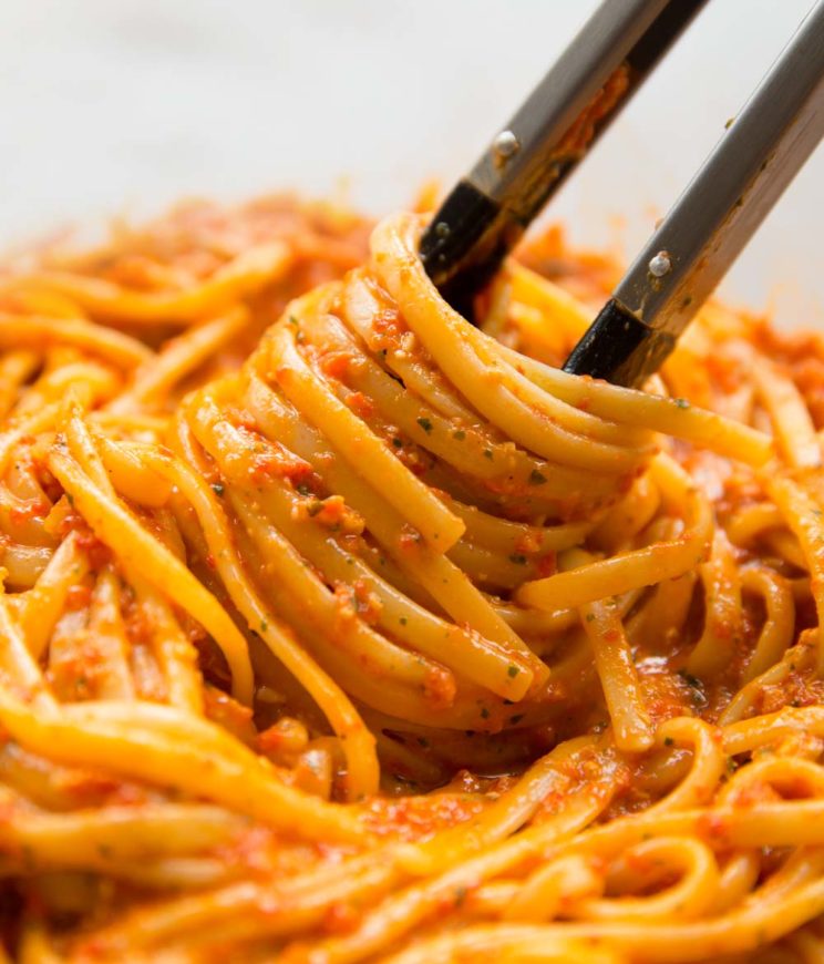 pasta tongs twirling in a bowl of linguine