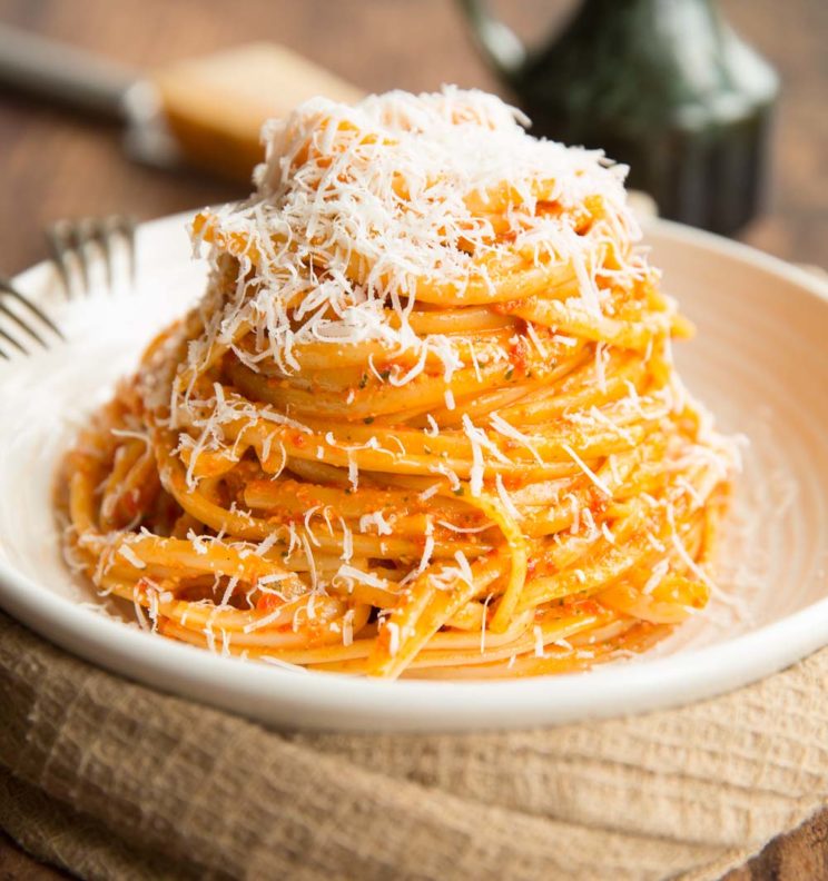 Roasted Red Pepper Pesto Pasta served on white plate with extra parmesan
