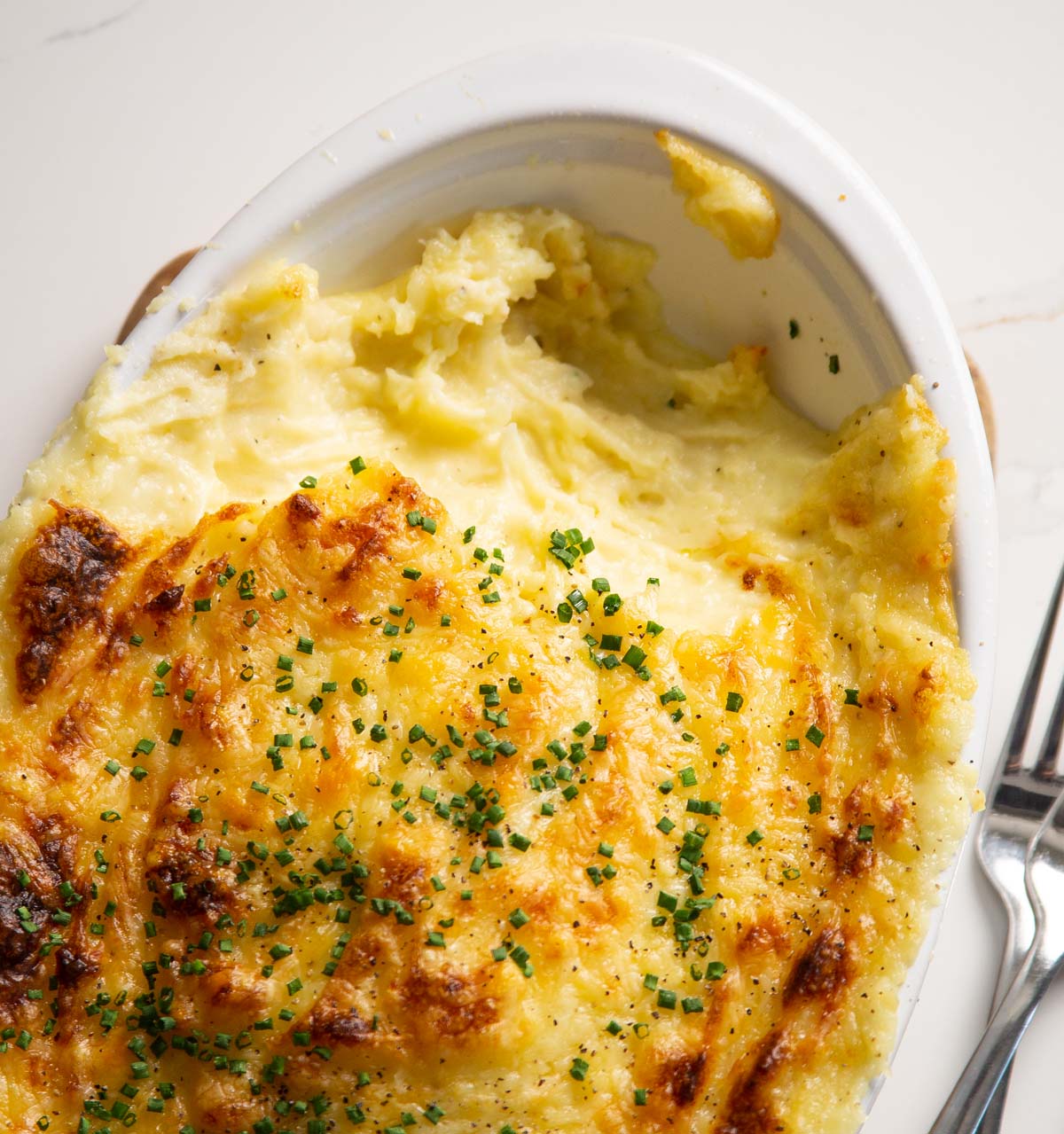close up overhead shot of cheese garlic mash with portion missing