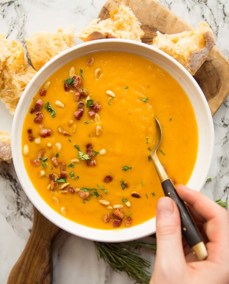 overhead shot of soup in a bowl with spoon digging in