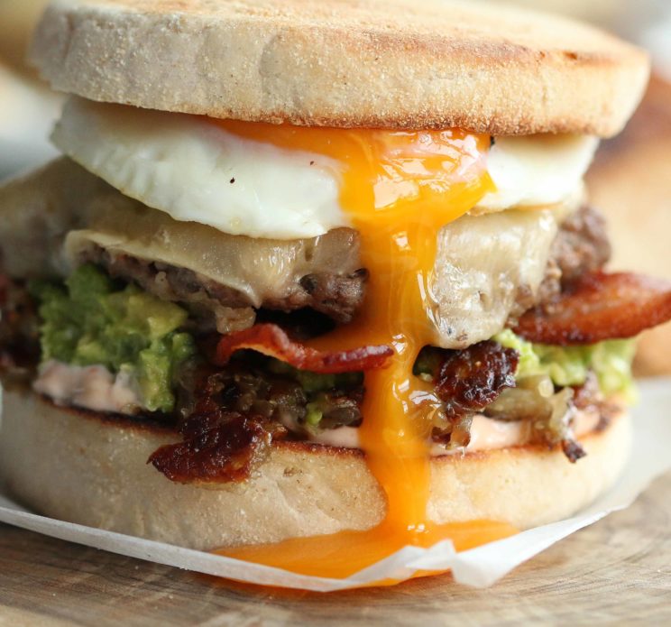 closeup of burger with egg yolk pouring down the centre
