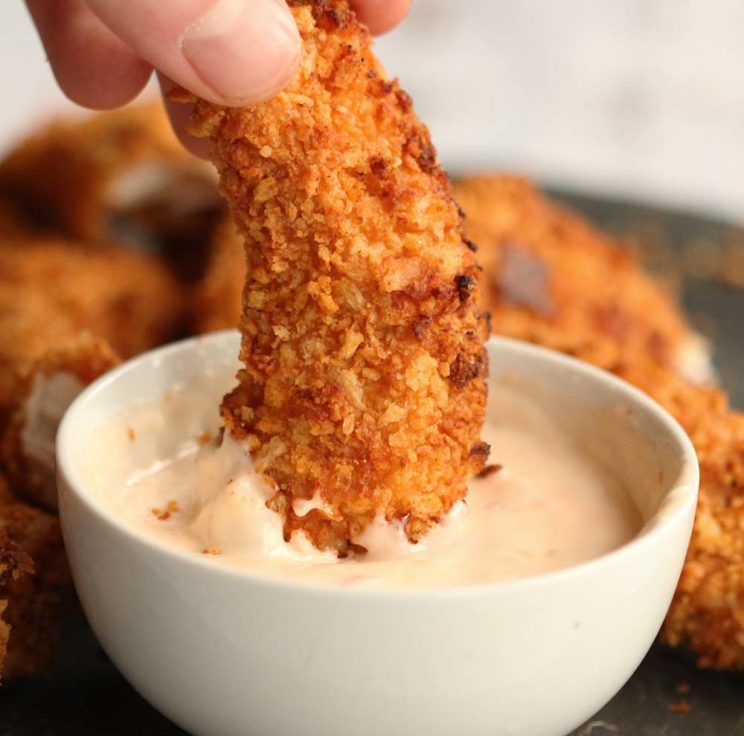 dunking chicken strip into dip