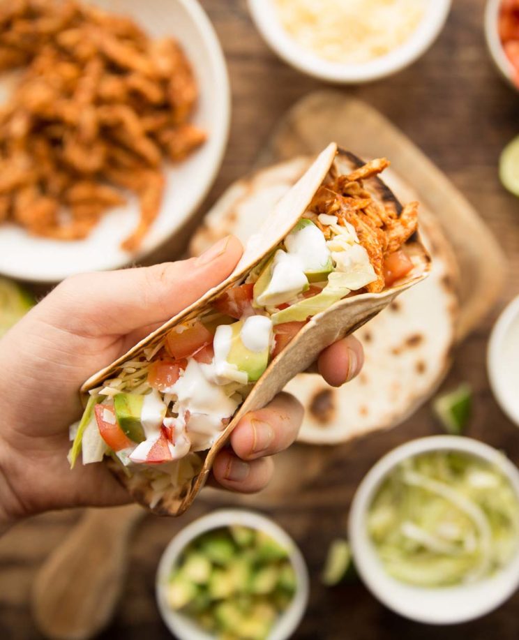 overhead shot of holding tacos up 