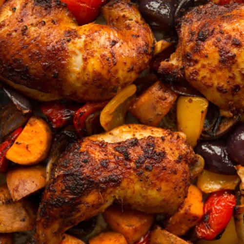 overhead shot of chicken leg tray bake in pan