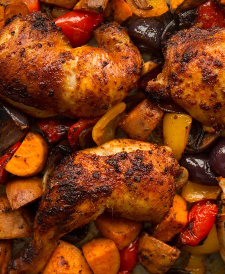 overhead shot of chicken leg tray bake in pan