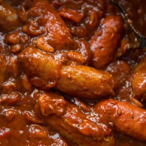 sausage casserole in pot with focus on pork sausage
