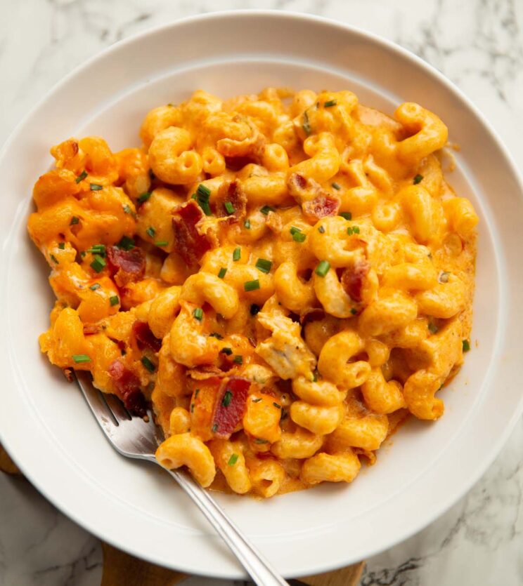 spicy buffalo chicken mac and cheese in large white bowl with silver fork