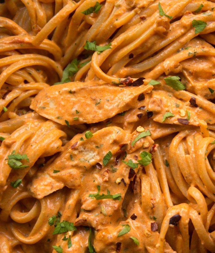 overhead shot of pasta in skillet with parsley to garnish