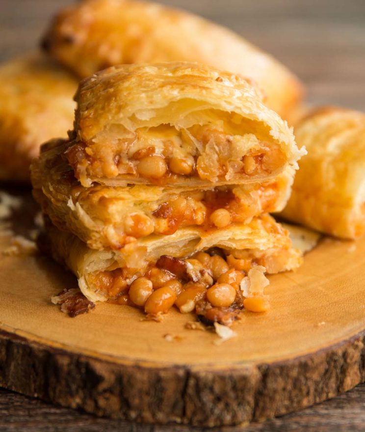 Cheesy Bean and Bacon Slices placed on chopping board with beans pouring out