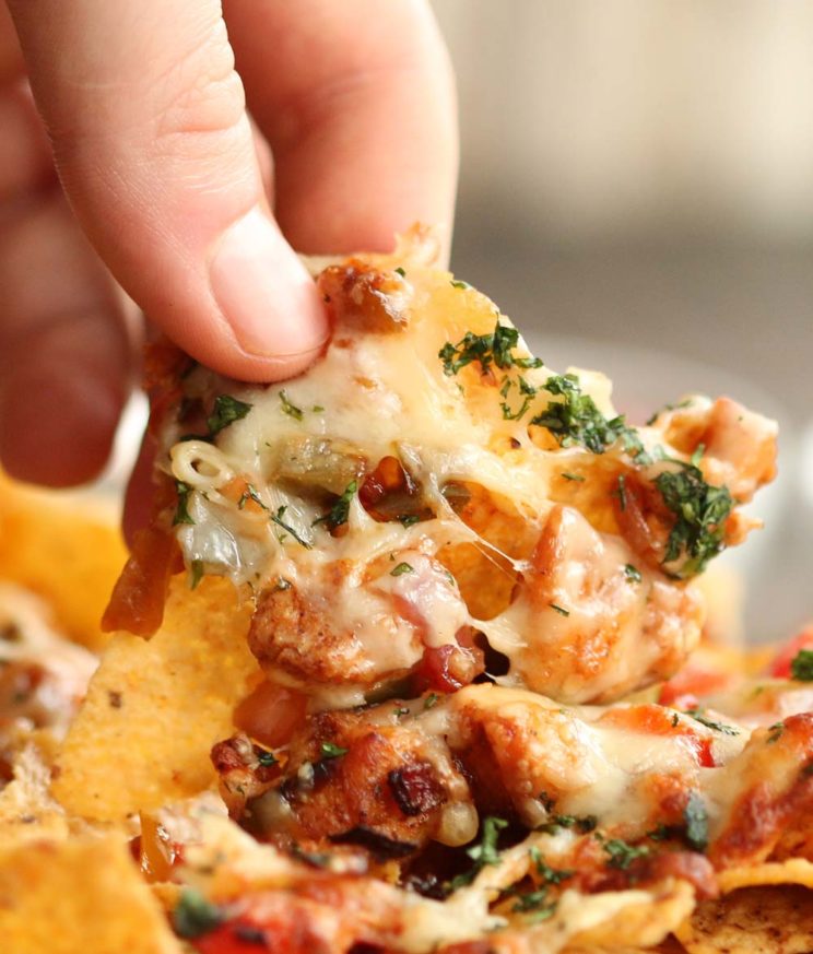 close up of pulling nacho with cheese pull