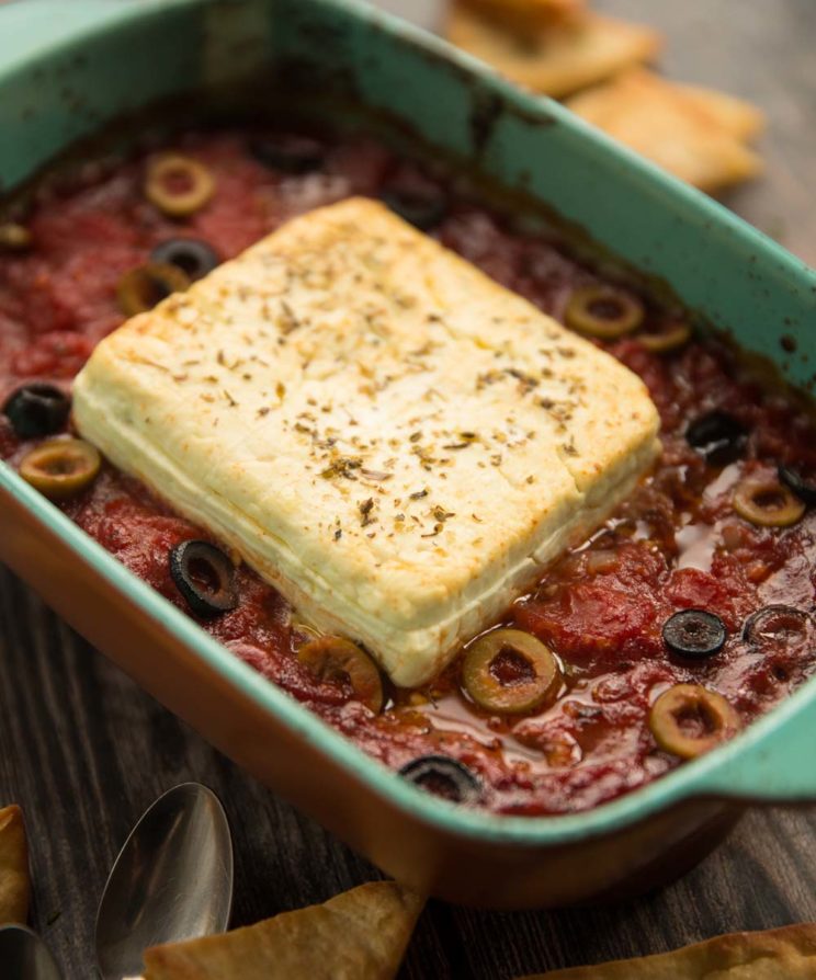 closeup shot of baked feta in tomato sauce fresh out the oven