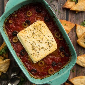 overhead shot of baked feta fresh out the oven surrounded by pita chips