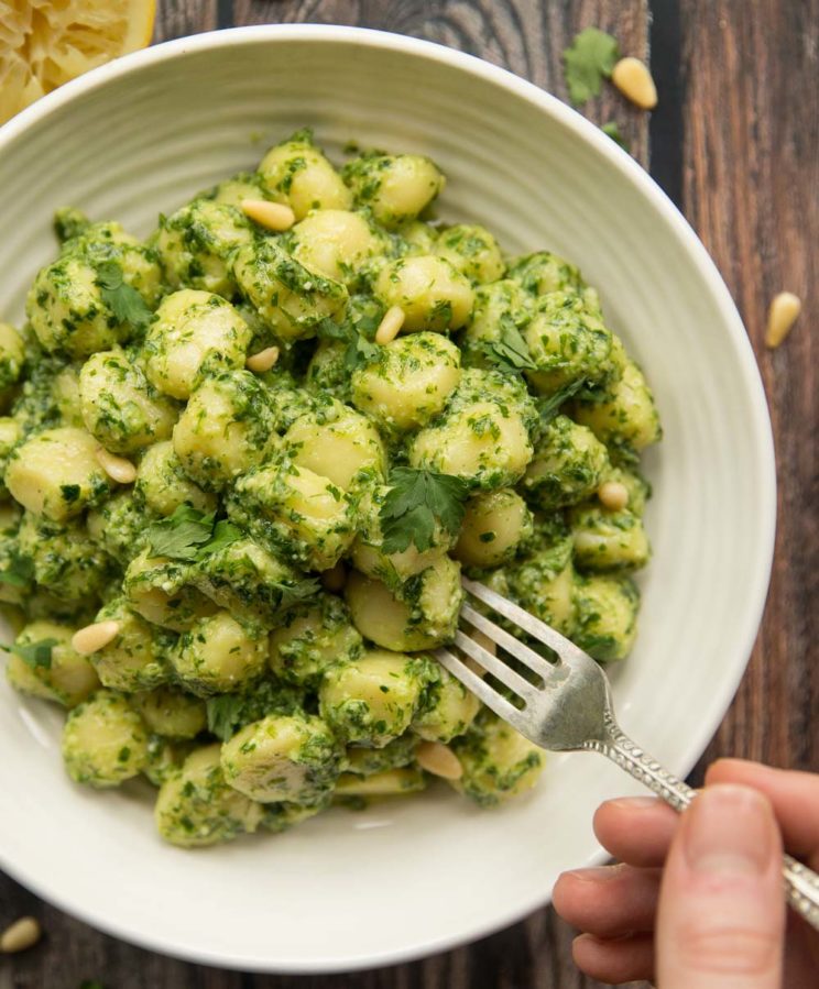overhead shot of Pesto gnocchi with chives and parsley
