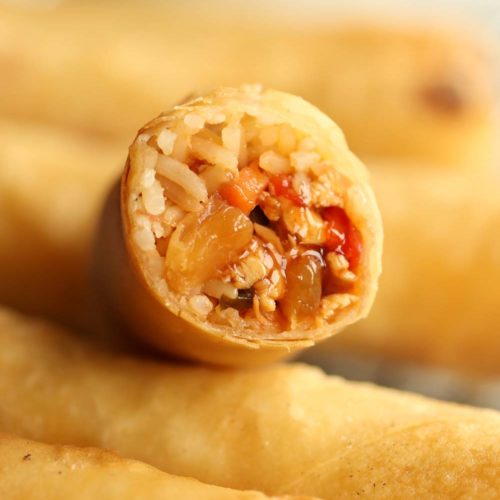 closeup shot of sweet and sour chicken filling inside spring roll