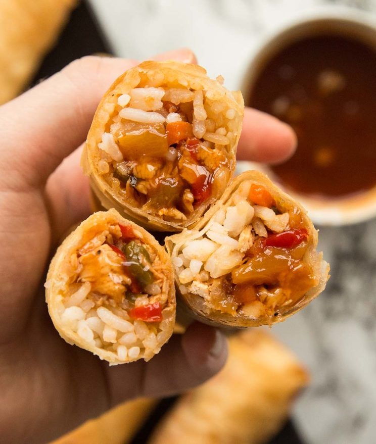 holding 3 open sweet and sour spring rolls open to camera