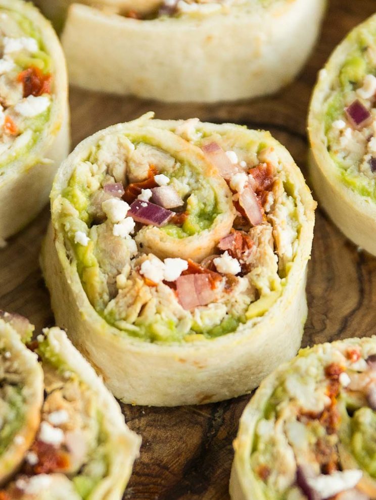 close up shot of tortilla roll up on wooden chopping board