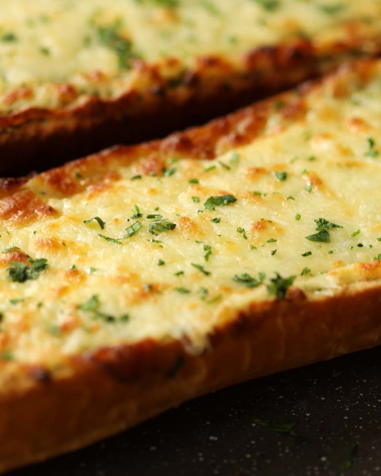 cheesy garlic bread fresh out the oven garnished with parsley