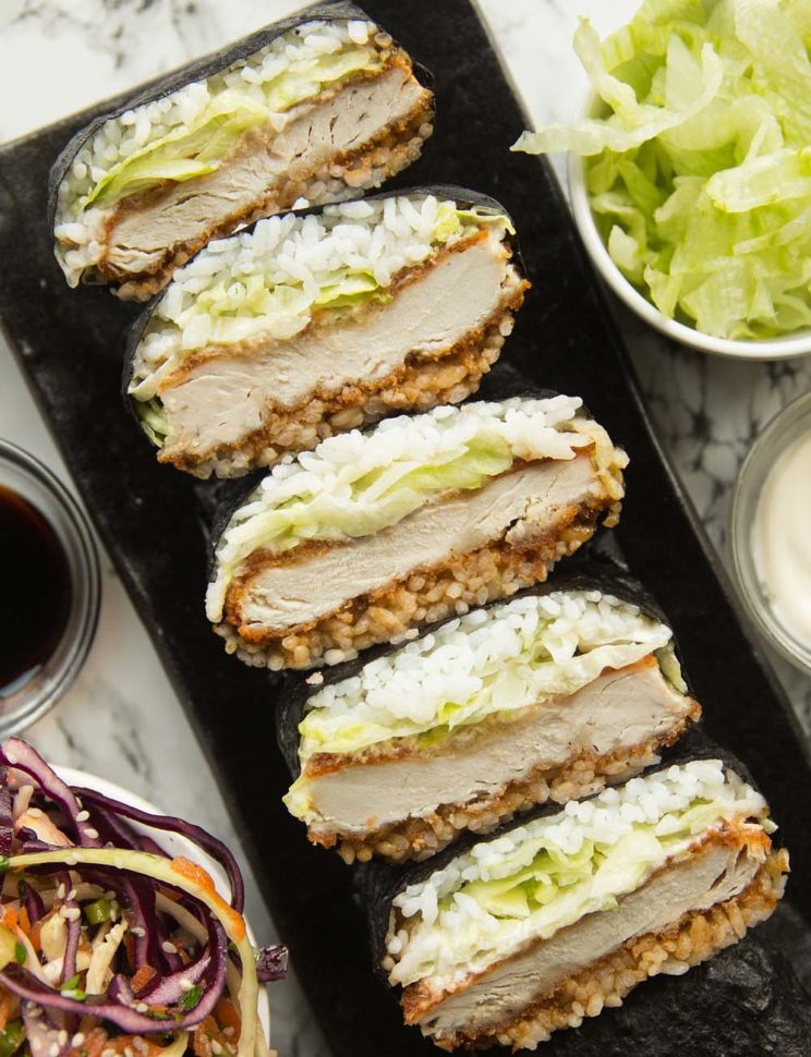 overhead shot of sushi sandwiches stacked on long plate