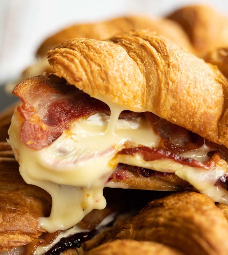 closeup shot of brie dripping out of croissant