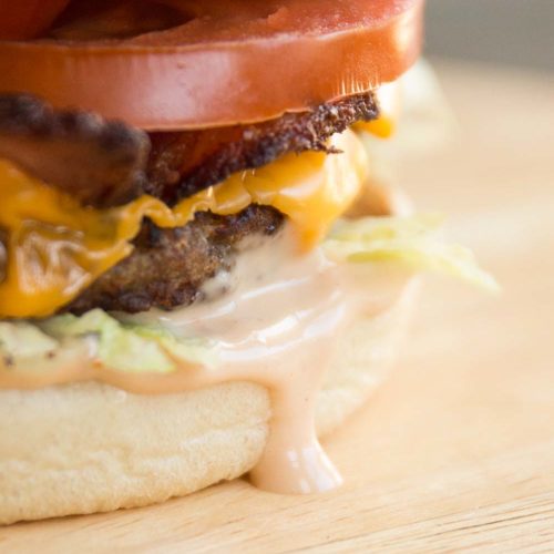 close up of burger sauce dripping down burger bun