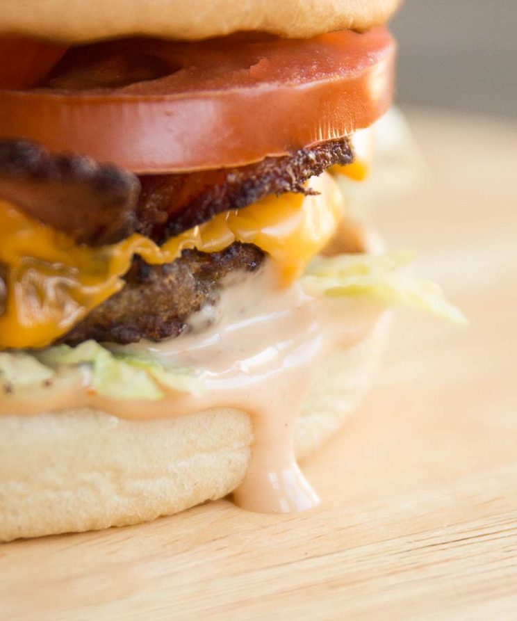 close up of burger sauce dripping down burger bun