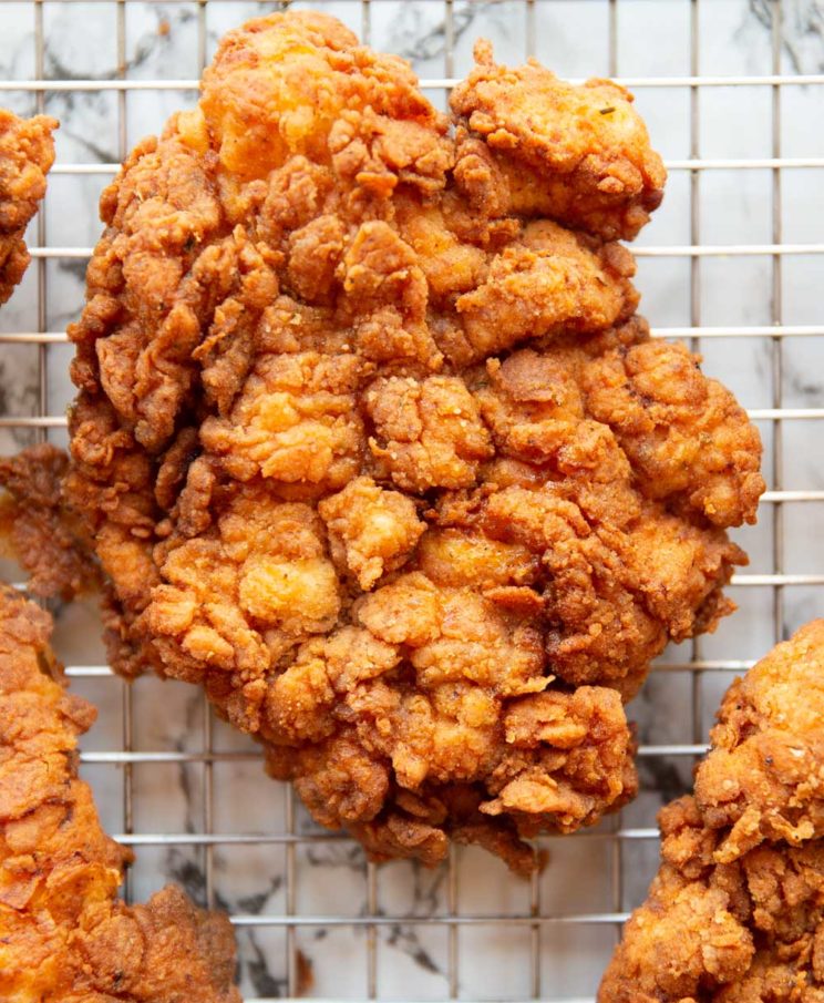 overhead closeup shot of fried chicken on wire rack