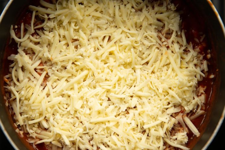 overhead shot of grated cheese on top of beans