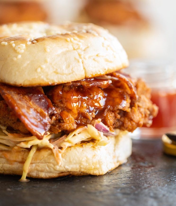 closeup shot of honey sriracha pouring down chicken