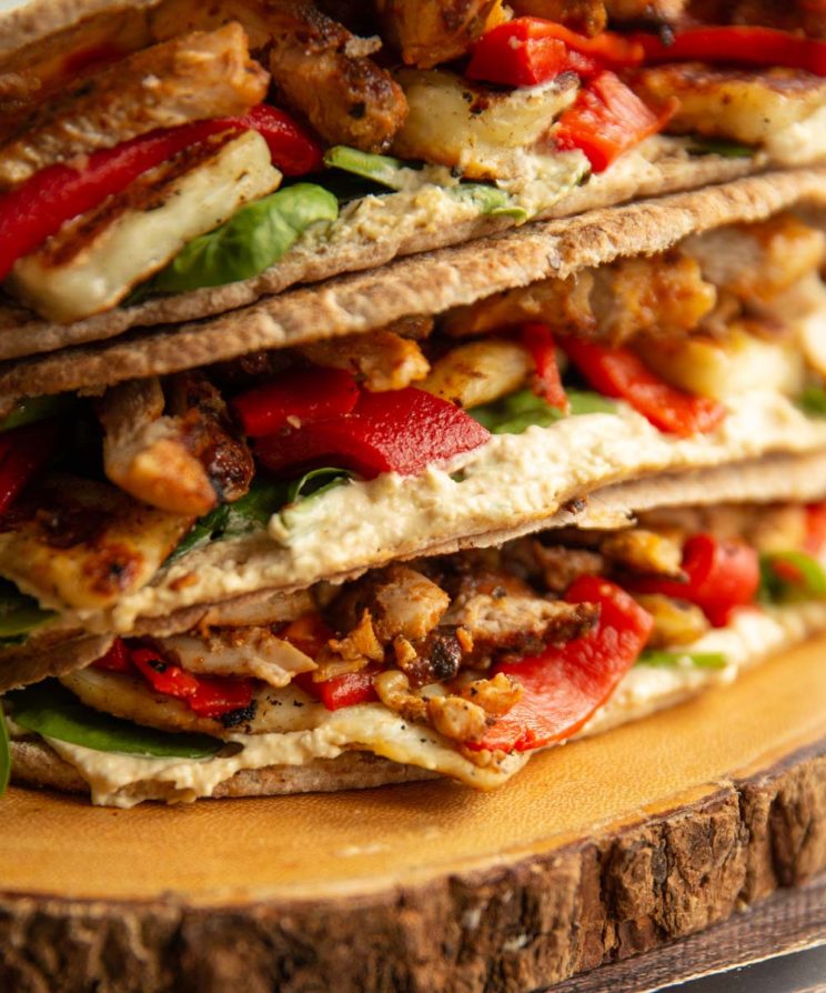 closeup shot of ingredients popping out of stacked pitas