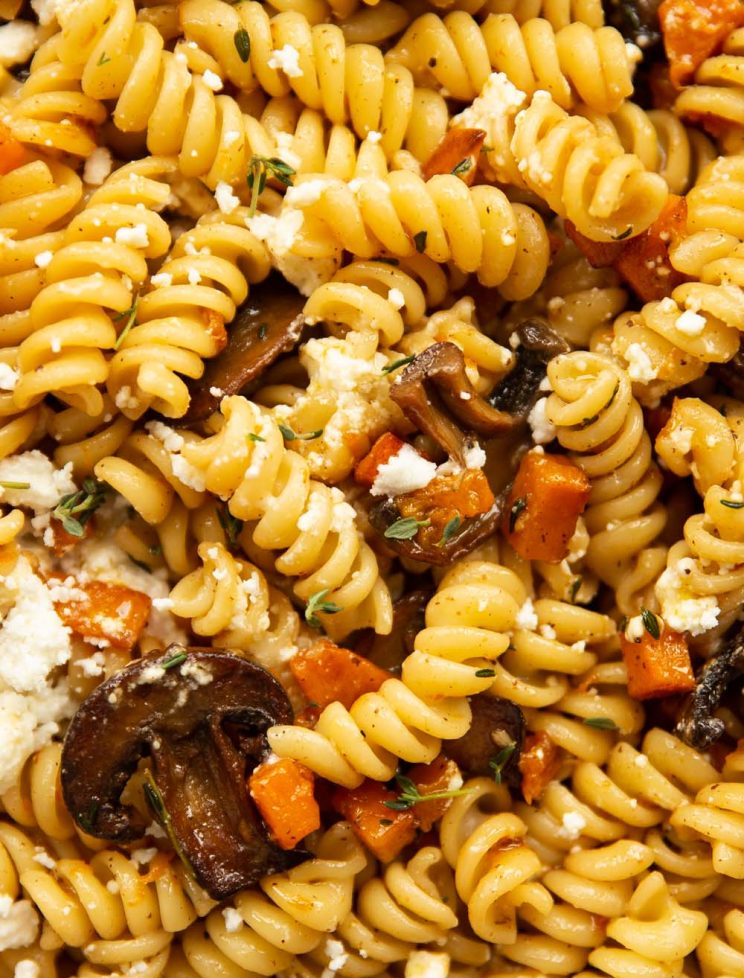 overhead shot of pasta in skillet sprinkled with goats cheese