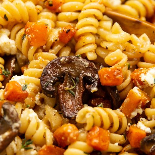 closeup shot focusing on mushroom resting on pasta