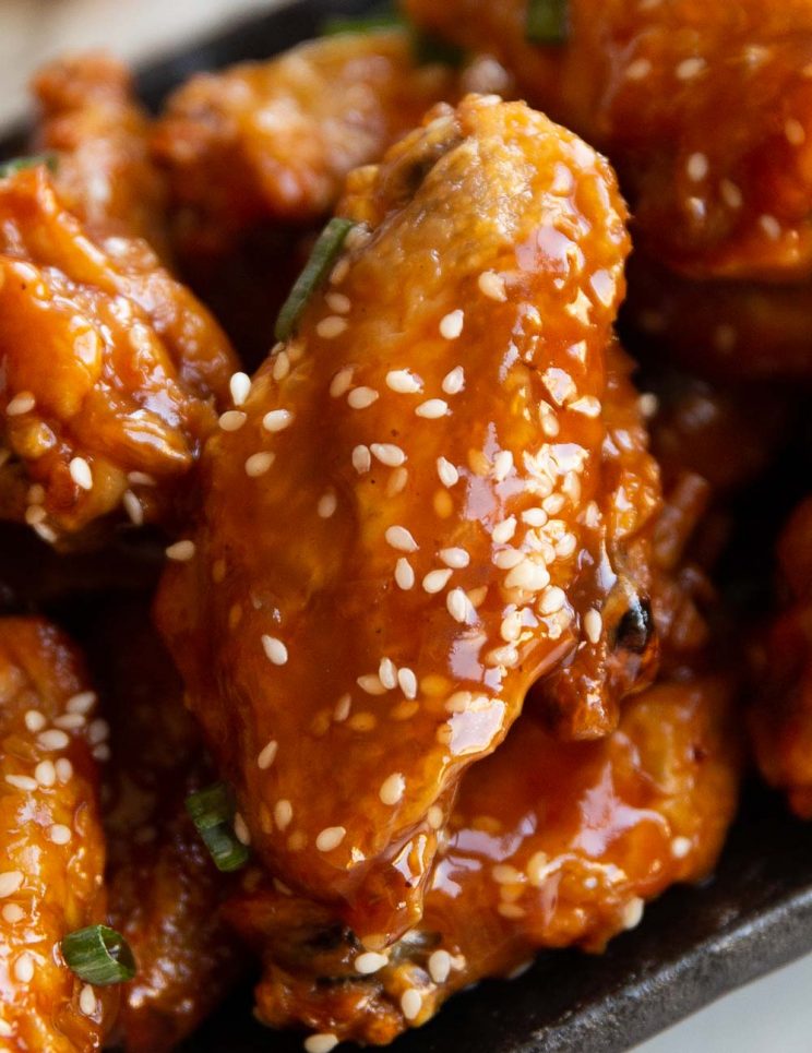 closeup shot of chicken wing garnished with sesame seeds