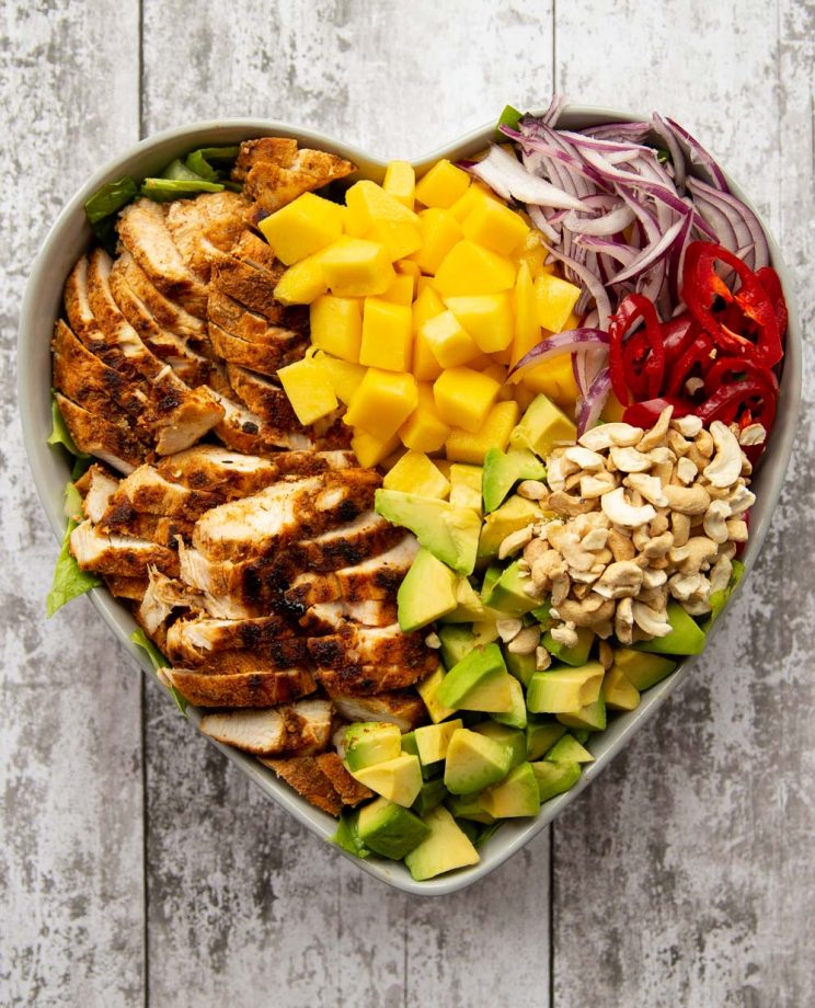 overhead shot of salad served in a heart shaped bowl