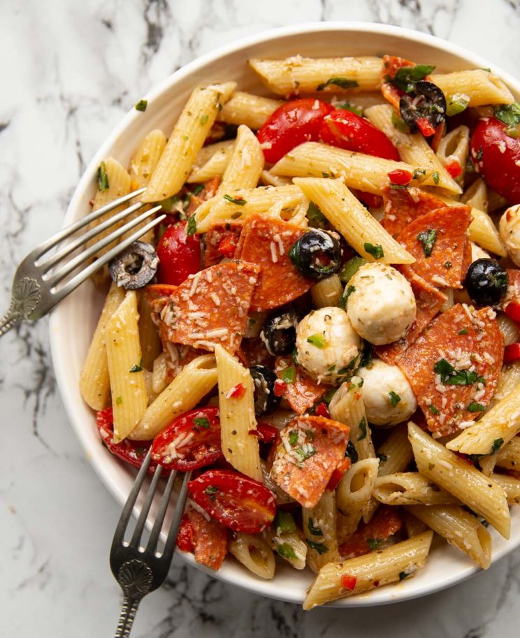 overhead shot of pasta in white bowl with two forks resting