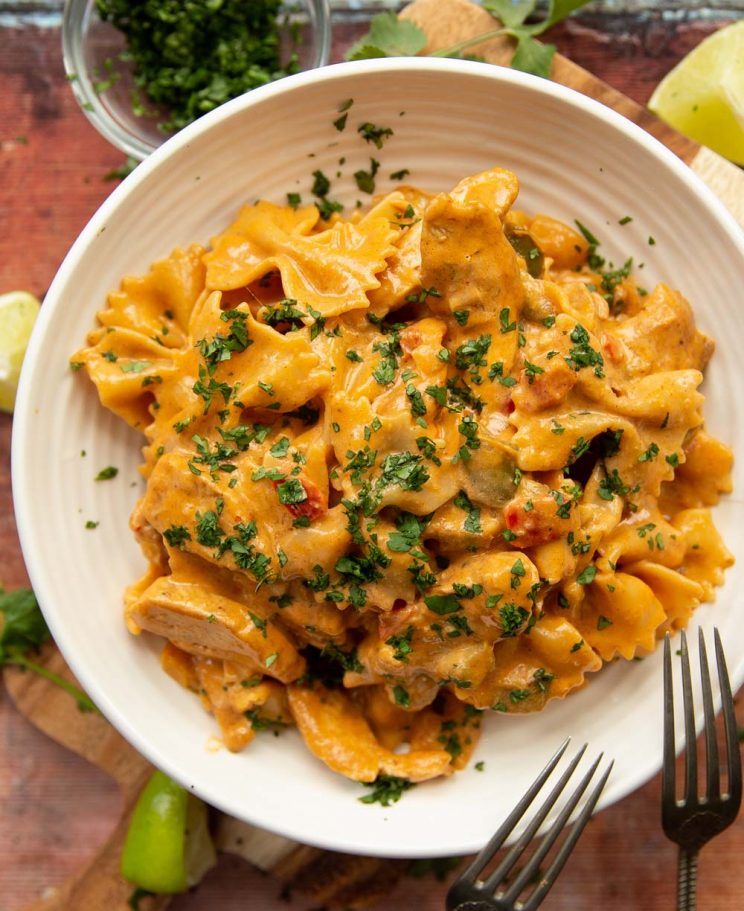 overhead shot of pasta in white bowl garnished with coriander