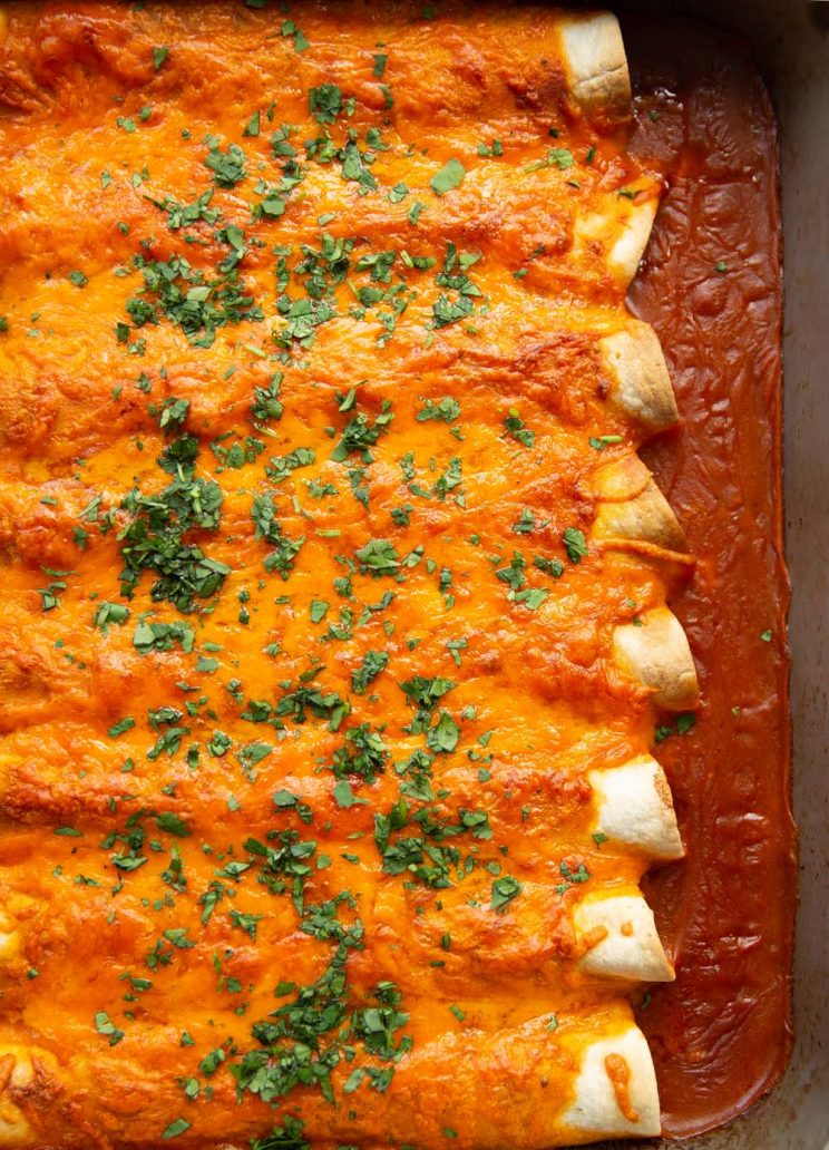 overhead shot of enchiladas fresh out the oven garnished with cilantro