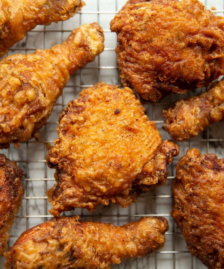 overhead shot of chicken on cooling rack fresh out the fryer