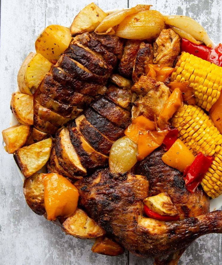 overhead shot of jointed chicken and veg on large white plate