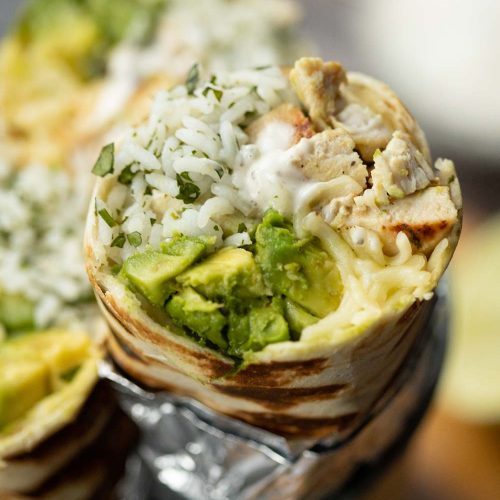 closeup shot of burrito sliced open showing filling