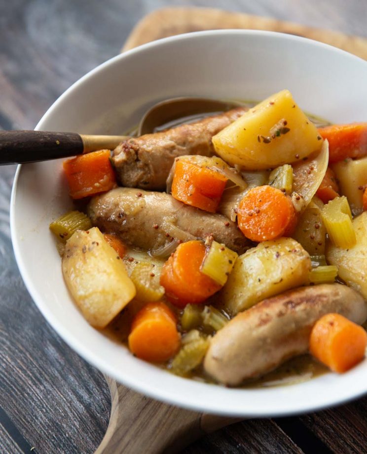 casserole served in white dish with golden spoon digging in