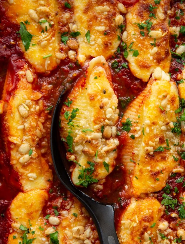overhead shot of shells fresh out the oven with serving spoon digging in